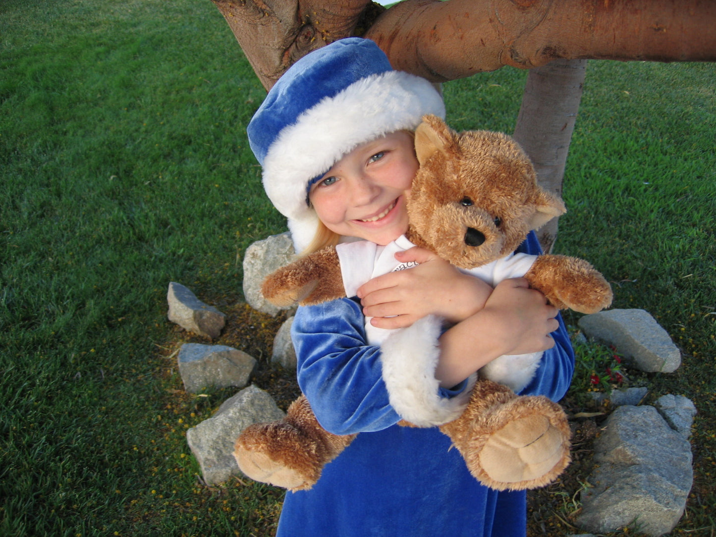 child hugging teddy bear